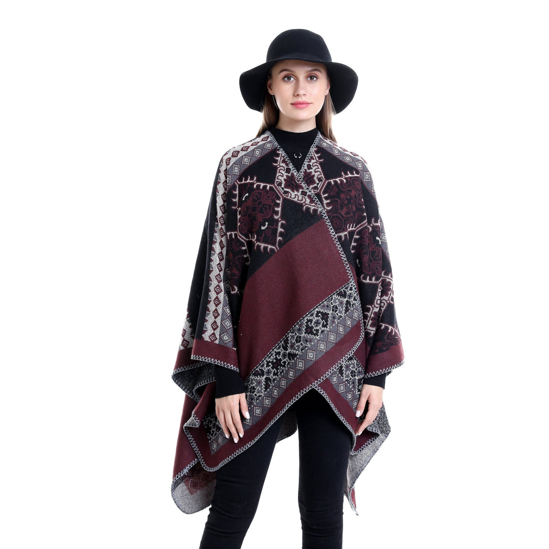 Dam Oversize Ruana poncho tillverkad av jacquard tyg med asymmetrical pointed edge och ornamental border