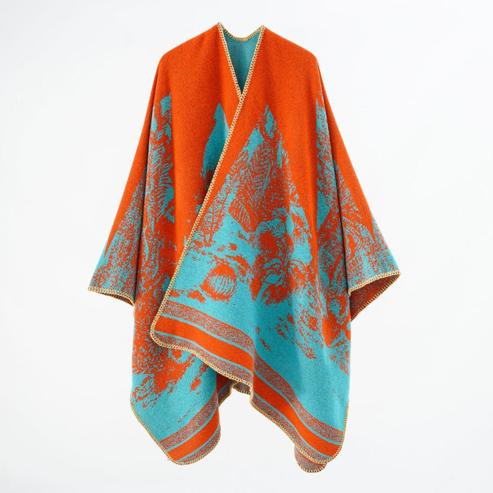 Dam capeponcho tillverkad av ullblandning med two-tone jacquard structure och decorative stitch border