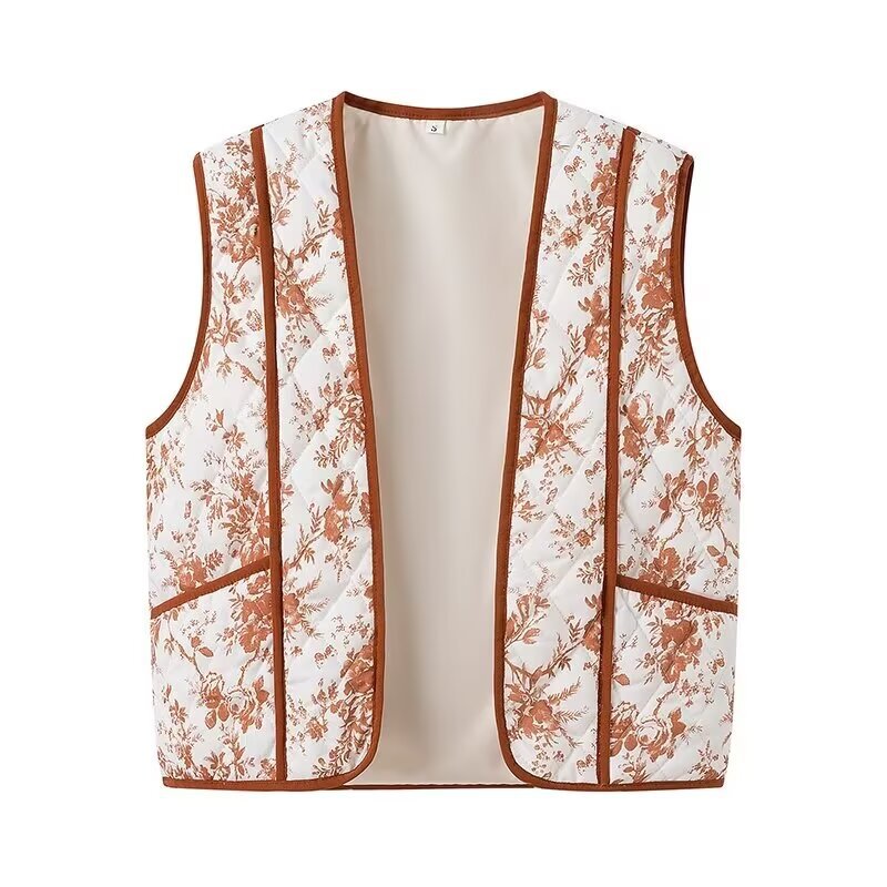 Dam light quiltad V-neck väst med floral alla-över tryck, kontrasterande piping och praktisk framfickor