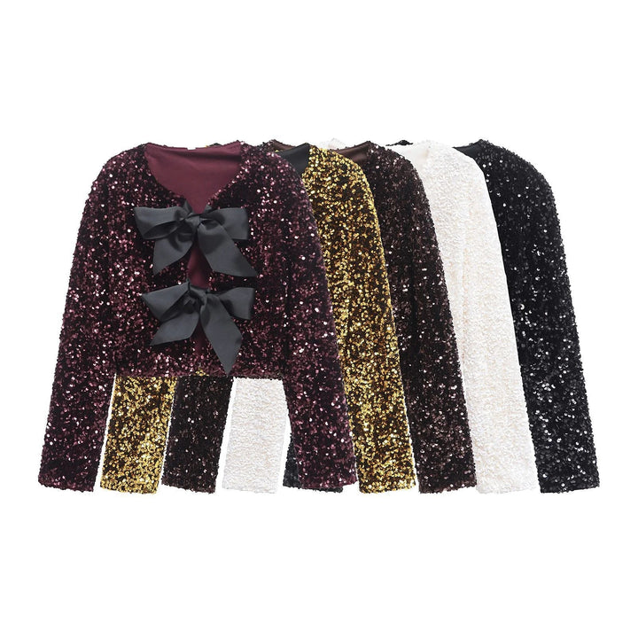 Dam sequin bolero jacka med double bow closure, vadderad foder och figurnära cropped skärning