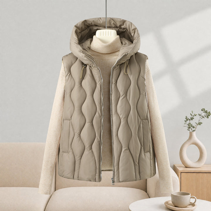 Dam longer skärning quiltad väst med huva, wave quiltning och detachable dragkedja