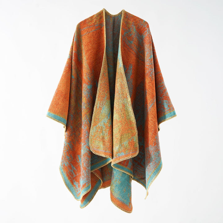 Dam jacquard stickad cape med textured woven look och öppen front